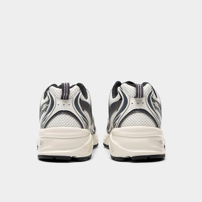 New Balance 530. Rear view of sea salt and magnet sneakers with padded heel panels, layered detailing and light midsoles.