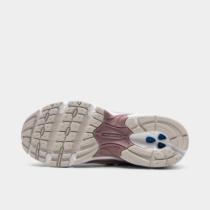 New Balance 740. Bottom view of silver metallic, raincloud and pebble sneaker showing cream and pink segmented outsole with textured tread pattern.
