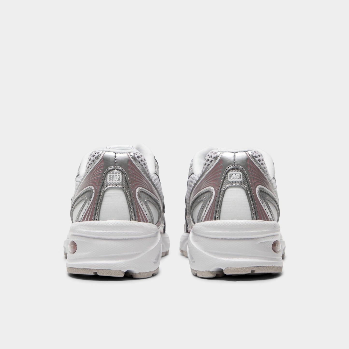 New Balance 740. Rear view of silver metallic, raincloud and pebble sneakers with padded heel panels, layered detailing and light midsoles.