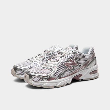 New Balance 740. Three-quarter view of silver metallic, raincloud and pebble sneakers with grey laces, layered overlays and pink N branding.