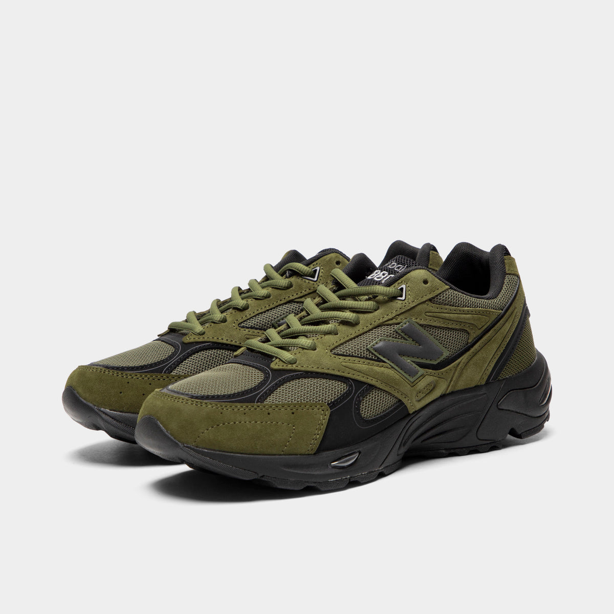 New Balance 880. Three-quarter view of a pair of low-top sneakers showing wakame olive green suede and mesh uppers, black trim accents, dark grey midfoot "N" logos, wakame green laces, and black cushioned soles. 