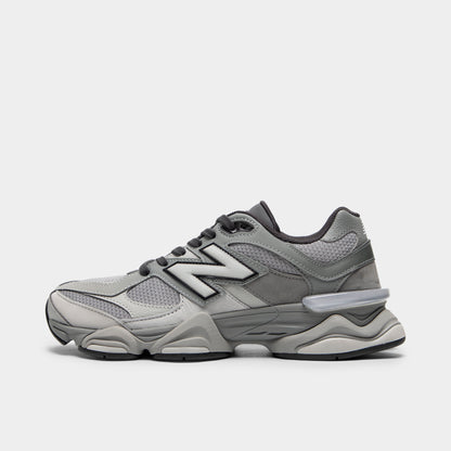 New Balance 9060. Side view of chunky lifestyle sneakers featuring a harbor grey mesh upper with slate grey pigskin suede overlays, silver "N" logo with black outline on the midfoot, dark grey laces, translucent CR device at the heel, sculpted dual-density ABZORB and SBS cushioned midsole, and a black rubber outsole. 