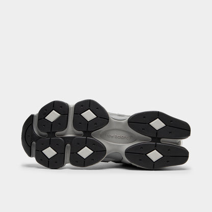  New Balance 9060. Bottom view of single shoe displaying full black rubber outsole featuring signature diamond-shaped pod tread pattern and central shank. 