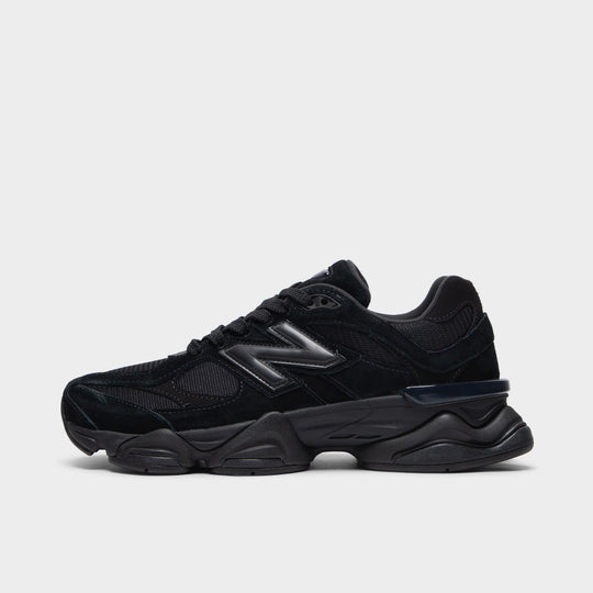 New Balance 9060. Side view of black and phantom sneaker with layered mesh panels, oversized N logo and sculpted sole.