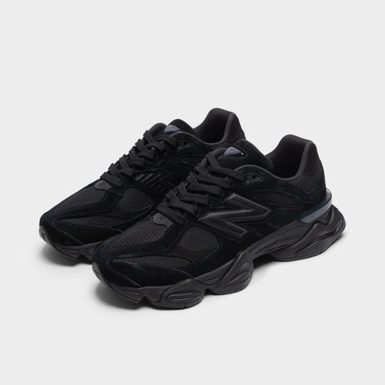 New Balance 9060. Three-quarter view of black and phantom sneakers with black laces, layered overlays and sculpted soles.