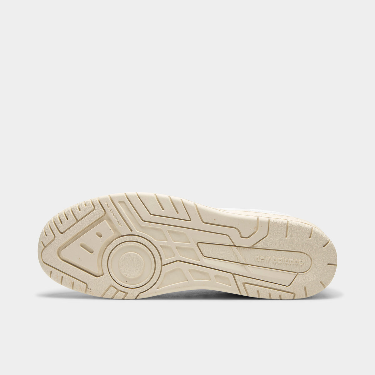New Balance 950. Bottom view of single shoe displaying full off-white rubber outsole with multidirectional tread pattern and center New Balance logo. 