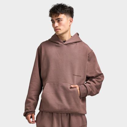 Unlike Humans Ridge Hoodie. Front view of model wearing coffee quarts hoodie with kangaroo pocket, drawstring-free hood and relaxed fit.