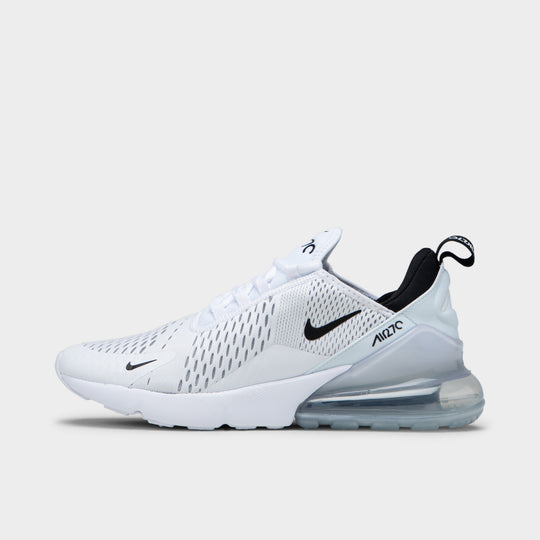 Nike Air Max 270. Side view of black and white sneaker with black Swoosh, mesh upper, heel pull tab and visible Air unit.